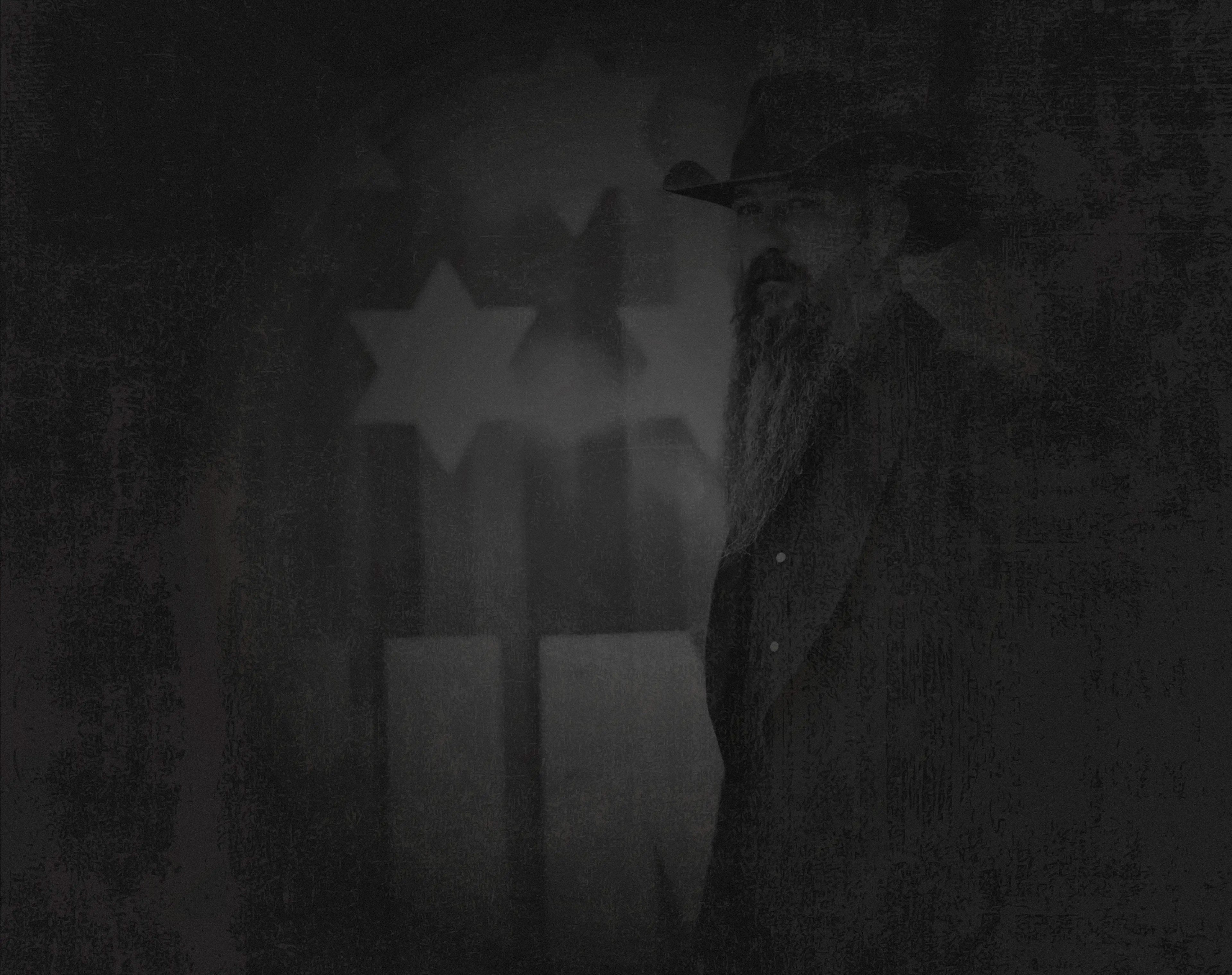 Stylized grunge black and white photo of Cody Jinks